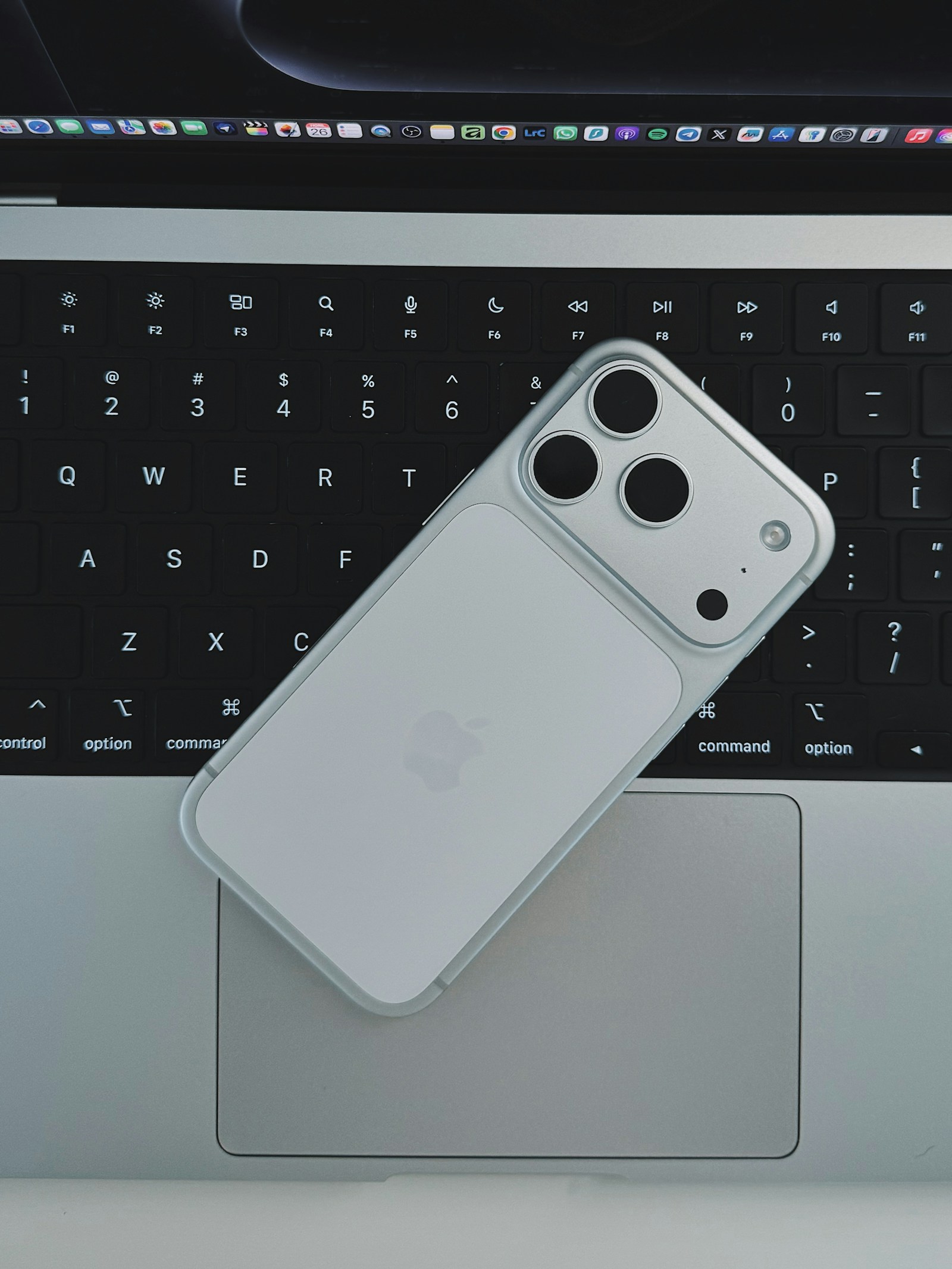 MacBook and iPhone prepared for MagicPad setup.